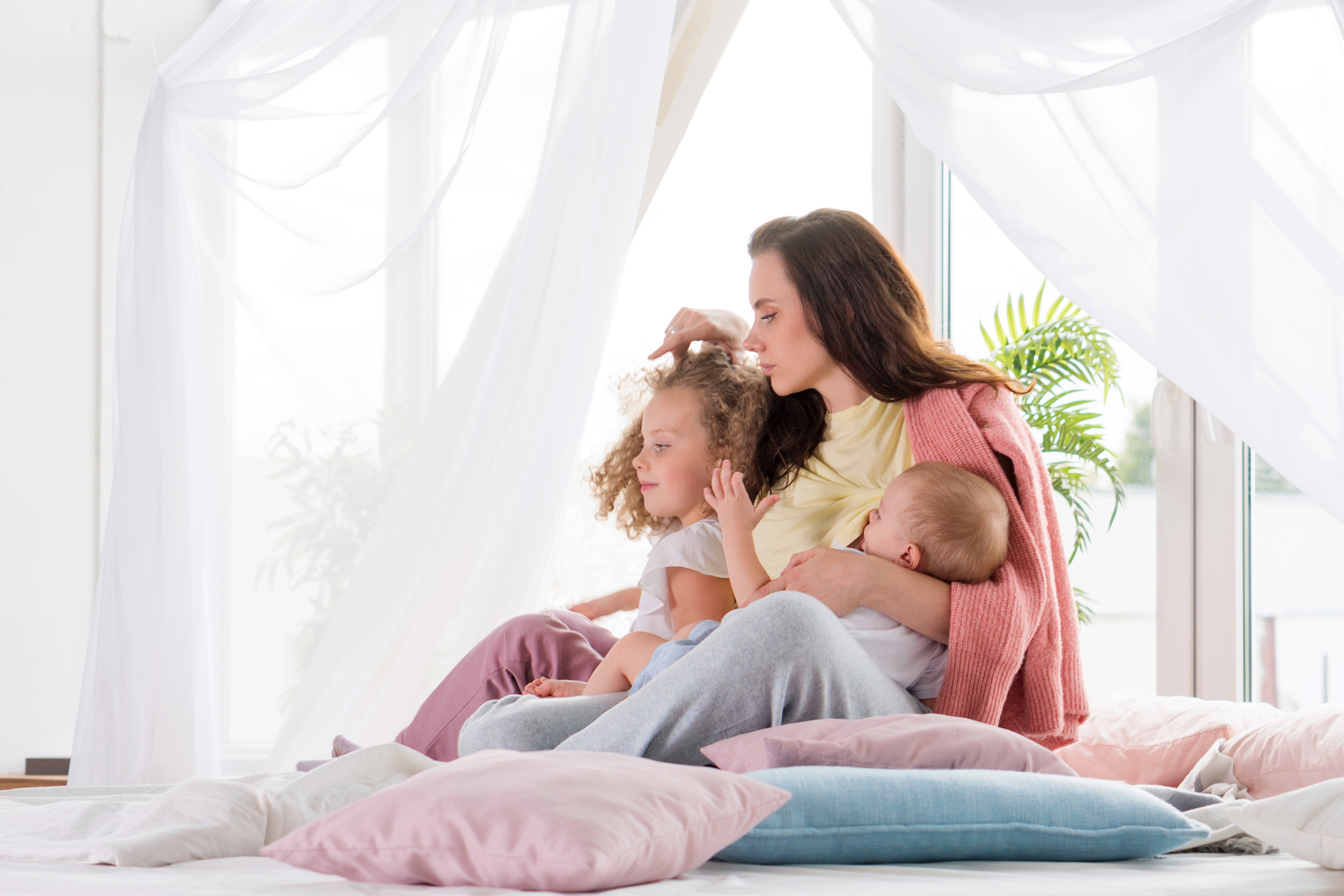Mother Taking Care of Kids in Bedroom