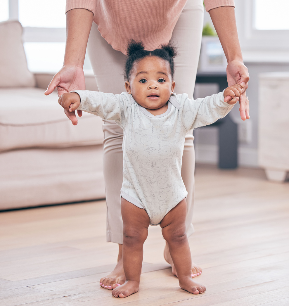 Hands Guiding a Baby Walk 